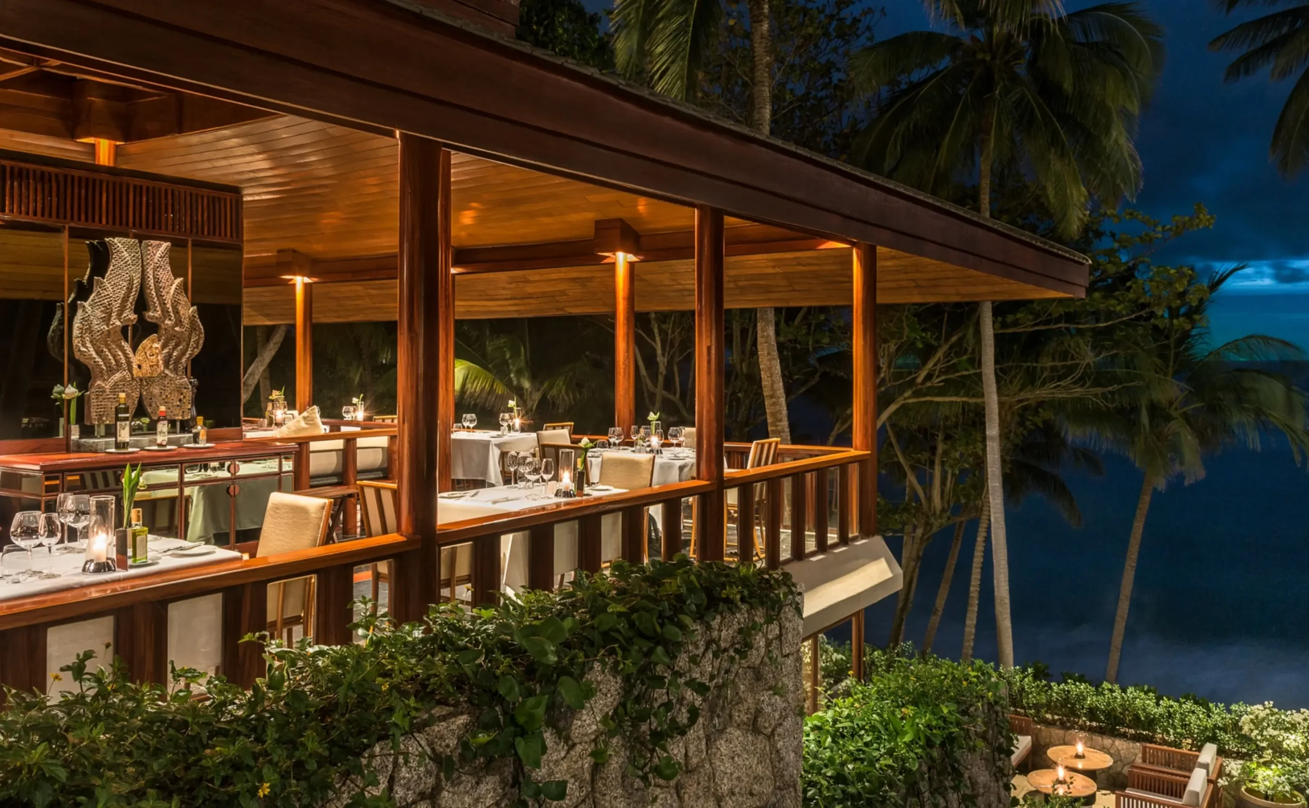 Arva restaurant terrace at Amanpuri lit for evening dining